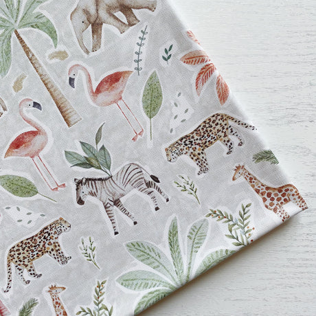 Jungle print splash mat featuring elephants, giraffes, flamingos, zebras, leaves and palm trees. 