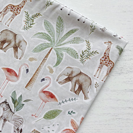 Jungle print splash mat featuring elephants, giraffes, flamingos, zebras, leaves and palm trees. 